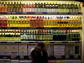 There's cash in those bottles. And the provincial government wants to squeeze every last cent out of them, even though bar and restaurant owners are starting to scream. (AP Photo/Alexander F. Yuan)