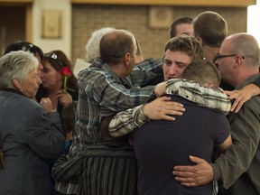 Family of Denis Blanchette console each other during funeral services Monday, September 10, 2012. Richard Bain is charged with first degree murder in the shooting death of Blanchette and wounding another man outside the Parti Quebecois election night rally. . THE CANADIAN PRESS/Ryan Remiorz