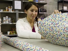 Lauren Oyama, 15, helps to wrap gifts for children at the West Island Mission in  Pointe-Claire.