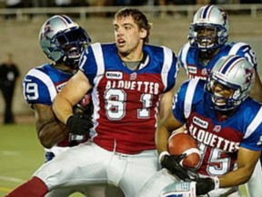 Patrick Lavoie's mobbed by teammates after scoring winning TD against Calgary.

Paul Chiasson/Canadian Press