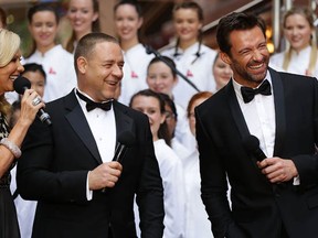 Russell Crowe and Hugh Jackman share a joke on the red carpet during the Australian premiere of Les Misérables at the State Theatre on Dec. 21, 2012 in Sydney, Australia.  Before you watch Les Misérables  with these guys, you might want to check out some other versions. (Brendon Thorne/Getty Images)