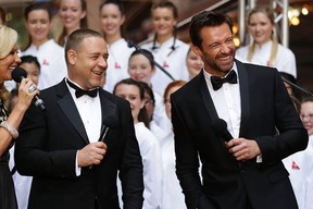 Russell Crowe and Hugh Jackman share a joke on the red carpet during the Australian premiere of Les Misérables at the State Theatre on Dec. 21, 2012 in Sydney, Australia.  Before you watch Les Misérables  with these guys, you might want to check out some other versions. (Brendon Thorne/Getty Images)