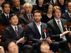 Japanese Crown Prince Naruhito, left, Australian actor Hugh Jackman, and British film director Tom Hooper applaud while attending a charity preview of  Les Misérables in Tokyo on Dec. 18, 2012.      (TOSHIFUMI KITAMURA/AFP/Getty Images)