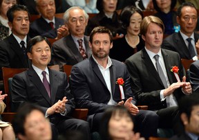 Japanese Crown Prince Naruhito, left, Australian actor Hugh Jackman, and British film director Tom Hooper applaud while attending a charity preview of  Les Misérables in Tokyo on Dec. 18, 2012.      (TOSHIFUMI KITAMURA/AFP/Getty Images)