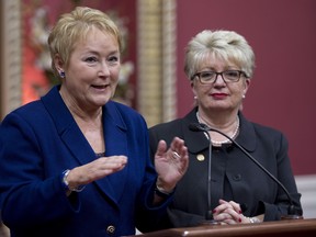 Quebec Premier Pauline Marois responds to reporters questions after her government tabled legislation that modifies the French Language law . Diane De Courcy, right, minister responsible for the French language law looks on. THE CANADIAN PRESS/Jacques Boissinot