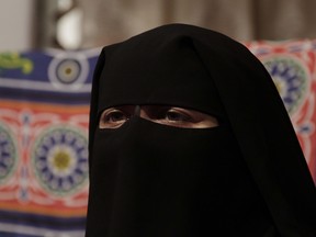 A woman wears a niqab in Cairo, Egypt, Monday, July 23, 2012. A sharply divided Supreme Court of Canada was not able to definitively rule Thursday whether a woman can wear a religious veil known as a niqab while testifying in court. THE CANADIAN PRESS/AP Photo/Maya Alleruzzo