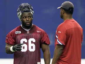 Defensive-lineman Ollie Ogbu chats with former Als' defensive-line coach Mike Sinclair.

John Mahoney/TheGazette