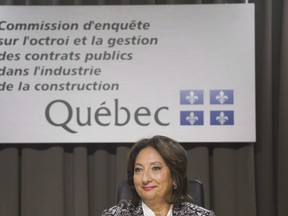 Justice France Charbonneau smiles as she sits on the opening day of a Quebec inquiry looking into allegations of corruption in the province's construction industry in Montreal, Tuesday, May 22, 2012.In the time it took Quebec's corruption inquiry to complete its fall sitting, three long-standing mayors had resigned, municipal parties were decimated or disbanded, and a shadow of suspicion spread over the political world. THE CANADIAN PRESS/Graham Hughes