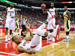 Lorenzo Brown #2 of the North Carolina State Wolfpack looks for a foul call after being knocked to the floor by Marcus Georges-Hunt #3 of the Georgia Tech Yellow Jackets during play at PNC Arena on January 9, 2013 in Raleigh, North Carolina. North Carolina State won 83-70.  (Photo by Grant Halverson/Getty Images)