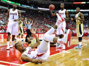 Lorenzo Brown #2 of the North Carolina State Wolfpack looks for a foul call after being knocked to the floor by Marcus Georges-Hunt #3 of the Georgia Tech Yellow Jackets during play at PNC Arena on January 9, 2013 in Raleigh, North Carolina. North Carolina State won 83-70.  (Photo by Grant Halverson/Getty Images)