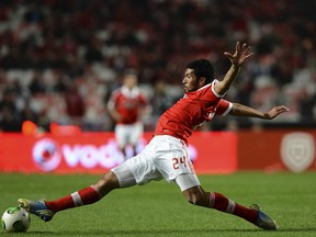 Benfica's Spanish defender Ezequiel Garay reaches for a ball during the Portuguese league football match SL Benfica vs FC Porto at Luz Stadium in Lisbon on January 13, 2013.   FRANCISCO LEONG/AFP/Getty Images
