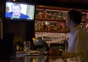 A photo illustration shows a man watching a TV showing disgraced cycling star Lance Armstrong with Oprah Winfrey is seen in a bar in downtown Los Angeles January 17. 2013.  During the interview Lance Armstrong admited doping while competing professionally in the sport.. AFP PHOTO / Robyn BeckROBYN BECK/AFP/Getty Images