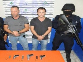 Canadians Stewart Goldstein, 50, center left and Daniel Selcer, 25, center right - appeared in Cozumel, Mexico criminal court Thursday, January 17, 2013. The pair were arrested In Playa del Carmen and are being charged with violating Mexico's weapons laws. (Por Esto)