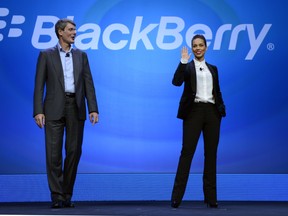 Blackberry CEO Tjrpstem Jeoms stands with Alicia Keys on stage.