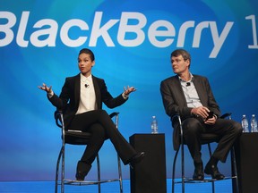 BlackBerry President and Chief Executive Officer Thorsten Heins (R) looks on as new BlackBerry Global Creative Director Alicia Keys speaks at the BlackBerry 10 launch event at Pier 36 in Manhattan on January 30, 2013 in New York City. The new smartphone and mobile operating system is being launched simultaneously in six cities.  (Photo by Mario Tama/Getty Images)