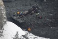 Rescuers search for missing workers in a quarry at L'Epiphanie, Que., Tuesday, January 29, 2013, following a landslide where a number of vehicles fell into the quarry. THE CANADIAN PRESS/Graham Hughes.