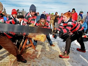 Evelyn Levac, left, and Meagan Dustin get support from the teammates on the Macdonald Woodsmen of McGill University during swede saw competition.