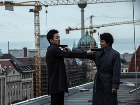 Spies Pyo (Ha Jeong-woo)  and Jung (Han Suk-kyu), have a rooftop standoff in the South Korean action thriller, The Berlin File. The film, directed by Ryoo Seung-wan, will open in Montreal on Friday, February 15, 2013, at the  Cineplex Odeon Forum Cinemas.