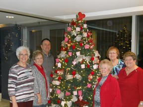 The Decorations Committee proudly poses next to their Valentine's Tree at Résidence Jean-Placide-Desrosiers in Ville Saint-Pierre. The spark of an idea, several days of hard teamwork and a good measure of pleasure have added up to a symbol of love and friendship for all to see.