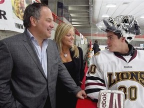 Lac St. Louis Lion goalie Nicholas Gavrielatos with his mother Josie Cacciatore and father Platon Gavrielatos before a practice.