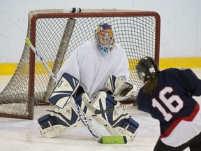 Pointe Claire's Andrea Lynch (16) takes a shot at T.M.R.'s goalie Annie Desrosiers.