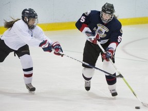 Pointe Claire's Lauren Houghton, right, moves puck past T.M.R. player.