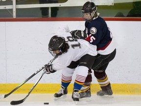 Kathleen Cooke of Pointe Claire battles Jennifer Doyle (18) of T.M.R. during game Saturday.