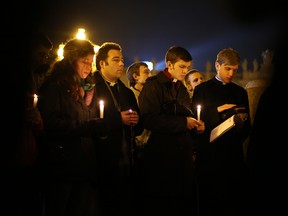 A group say prayers in St Peter's Square for Pope Benedict XVI in the moments before he ceased to be Pontiff at 8 p.m. (Rome time) on February 28, 2013 in Vatican City, Vatican. Pope Benedict XVI has been the leader of the Catholic Church for eight years and is the first Pope to retire since 1415. He will stay at the Papal Summer residence of Castel Gandolfo until renovations are complete at a monastery in the grounds of the Vatican, and will be known as Roman pontiff emeritus or pope emeritus.  (Photo by Peter Macdiarmid/Getty Images)