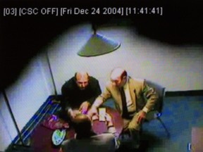 A video still frame from an RCMP surveillance video shown during the Charbonneau Commission last September allegedly shows Nick Rizzuto Sr., (R) exchanging tens of thousands of dollars with Nicolo Milioto (L), then the head of Mivela Construction Inc. and Rocco Sollecito. Milioto told the commission today that he had no regrets over his friendship with Rizzuto.  ( Phil Carpenter/ THE GAZETTE)