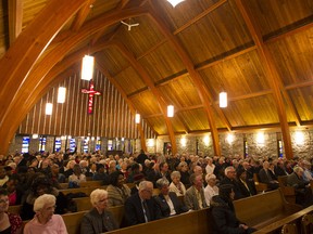 This file photo from Nov. 25 of last year shows the congregation taking part  in the last service at St. Paul's Anglican Church in Lachine in Montreal. The church closed its doors on due to a declining number of parishioners. But a recent survey suggests that Quebecers religious attachment may be increasing. (Dario Ayala/THE GAZETTE) ORG XMIT: 45066