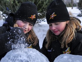 Olivia May and Annabelle Fortin try their hand at ice sculpting.