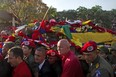 Venezuelans accompany the funeral cortege of late Venezuelan President Hugo Chavez on its way to the Military Academy, on March 6, 2013, in Caracas. The flag-draped coffin of Venezuelan leader Hugo Chavez was borne through throngs of weeping supporters on Wednesday as a nation bade farewell to the firebrand leftist who led them for 14 years. EITAN ABRAMOVICH/AFP/Getty Images