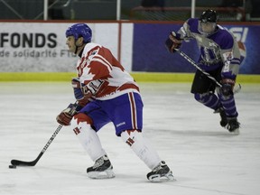 Guy Carbonneau clears the puck from his end.