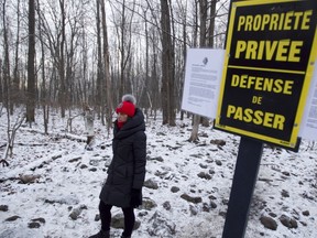 Councillor Rhonda Massad beside signs that went up in December 2011, informing walkers that they were trespassing.