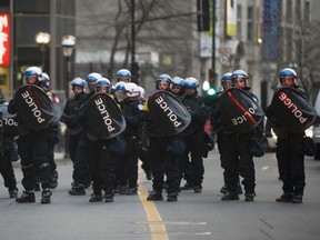 Police block off a section of Sherbrook Street during the 2012 edition of the annual anti-police brutality demonstration in Montreal. Given the protest's history, expect to see the same images tomorrow night. [THE GAZETTE/Graham Hughes]