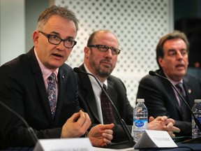 Quebec Health Minister Rejean Hebert, left, announces the Centre Hospitalier Lachine will remain part of the McGill University Health Centre. To his left are Marquette MNA Francois Ouimet and Normand Rinfret, director general and CEO of the MUHC.