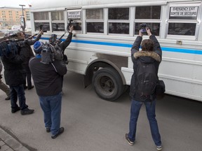 News photographers, hoping to get a shot of Luka Magnotta, try to take pictures through the windows of a Correctional Services bus, at Palais de Justice in Montreal on Monday. Today was the first day of preleminary hearings for Magnotta, who is charged with the murder of Lin Jun in 2012.  Magnotta's  lawyer Luc Leclair is requesting a closed courtroom for the hearings.  ( Phil Carpenter/ THE GAZETTE)