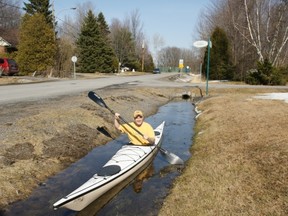 Area resident Steve George Kayak demonstrates the depth of the ditch in front of his home Condora Crescent in the Chaline Valley.