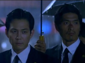 Lee Jung-jae plays Lee Ja-sung, a man caught between two worlds. (Caught in the rain, as well, in this photo.) He holds a powerful position in a criminal organization; only three people know that hes really an undercover policeman.