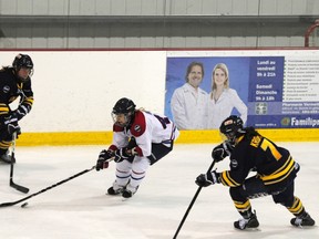 MONTREAL, QUE.: MARCH 9 2013 - The Montreal Stars (white) faced Alberta in CWHL action last Saturday at the St Lazare Arena. The second place Stars won 6-2 over last place Alberta. Emmanuelle Blais (white) skates between two Alberta defenders. (Navneet Pall/The Gazette)