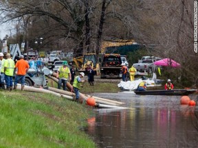 Crews clean up in Mayflower, Arkansas after the Pegasus pipeline spilled thousands of litres of oil into the town.