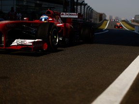 Fernando Alonso of Spain and Ferrari drives into the pitlane prior to the Chinese Formula One Grand Prix at the Shanghai International Circuit on April 14, 2013 in Shanghai, China. (Ronaldo Schemidt/AFP/Getty Images)