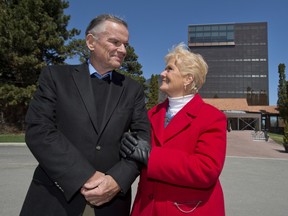 Anne-Marie Edward's parents Jim and Suzanne pose in front of John Abbott College building to be named for their daughter. (Graham Hughes/THEGAZETTE)