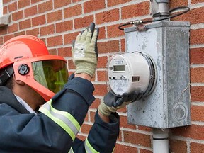 Technician installs a new Hydro smart meter at a home in Dorval on April 9.