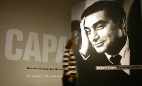 BERLIN, GERMANY:  A woman walks past a poster showing a portrait of Hungarian-French war photographer Robert Capa, 21 January 2005 at the Martin-Gropius-Bau in Berlin.  (JOHANNES EISELE/AFP/Getty Images)
