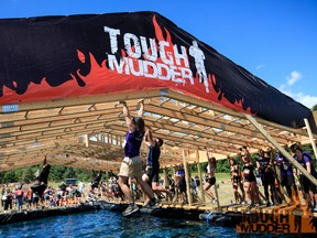 Some of the bars in the Funky Monkey obstacle were greased with mud and butter to make not falling into the icy water below nearly impossible. (photo by Dmitry Gudkov c/o Tough Mudder)