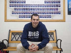 Jeff Shoer sits in front of photo of BHS Class of 1990. (Graham Hughes/THE GAZETTE)