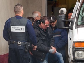 In this file photo from December of 2012, a shackled Raynald Desjardins enters a Securite Publique van outside the courthouse in Joliette. Desjardins, who is charged with the first-degree murder of Salvatore (Sal the Ironworker) Montagna, was denied bail today. (Vincenzo D'Alto / THE GAZETTE)