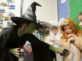 Dressed as the Wicked Witch of the West, Evergreen Elementary School principal Kathleen O'Reilly, teases students dressed for Wizard of Oz skit.