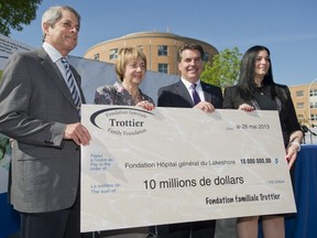 From left, Lorne and Louise Trottier hold up a cheque alongside Lakeshore General Hospital Foundation president Silvana Orrino and WI HSSC Director General and CEO Benoit Morin during a ceremony at the hospital in Pointe-Claire, west of Montreal, Tuesday, May 28, 2013, where the Trottier's made a $10-million donation on behalf of their family foundation to the LGH Foundation.donation to